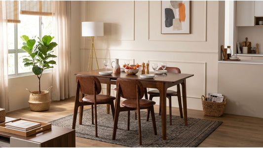 Acacia wood dining table with brown chairs on a patterned rug in a warm Singapore dining room