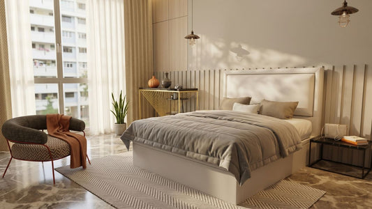 Beige upholstered bed frame in a modern Singapore bedroom with accent chair and warm natural light