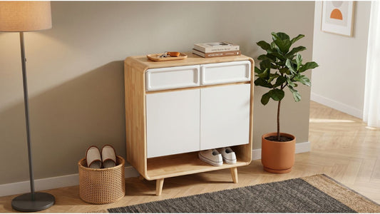 Compact wood and white shoe cabinet with open shoe shelf in a bright HDB foyer with plant and basket