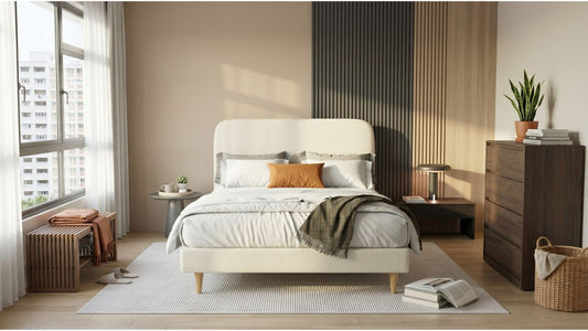 Coordinated bedroom furniture set in a modern Singapore bedroom with cream upholstered bed frame, bedside table, chest of drawers, and bench