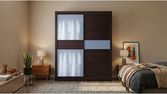 Dark wood-look MDF sliding wardrobe with frosted panels beside a bed in a warm HDB bedroom