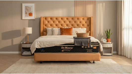 Dr Maxis quilted top mattress styled on orange bed frame in a warm modern Singapore bedroom