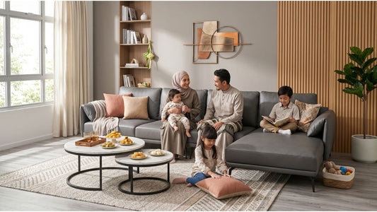 Family hosting a Hari Raya open house with grey sectional sofa and round coffee tables in a Singapore HDB living room