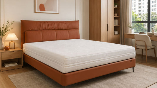 Modern white mattress on a warm brown upholstered bed frame in a practical Singapore bedroom for choosing the right mattress