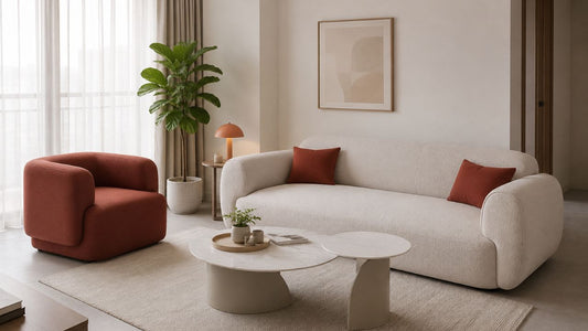 Layered seating with cream sofa, terracotta accent chair, coffee table, and rug in a modern Singapore living room.