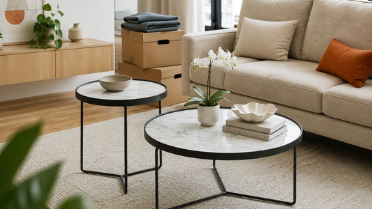 Round marble coffee tables beside a beige sofa in a Singapore living room with moving boxes for furniture move preparation