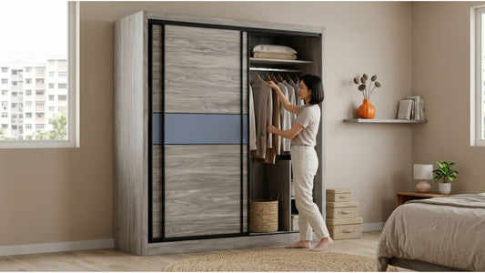 Modern HDB bedroom with grey wood sliding wardrobe, open clothing section, neutral bed styling, and compact storage decor
