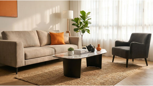 Modern marble coffee table with beige sofa and grey armchair in a bright Singapore home