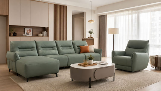 Sage green modular sofa with matching armchair in a warm modern Singapore living room with wood accents, coffee table, rug, and natural daylight