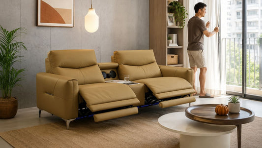 Tan reclining sofa in a bright Singapore HDB living room with homeowner opening curtains to prevent mould on furniture.