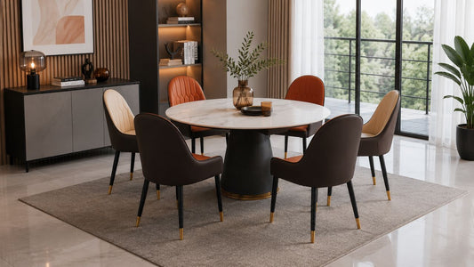 Round marble dining table with mixed colour chairs in a bright modern Singapore dining room