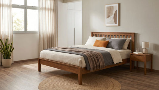 Rubberwood bed frame in a warm Singapore bedroom with matching bedside table, soft bedding, indoor plants, and natural window light.