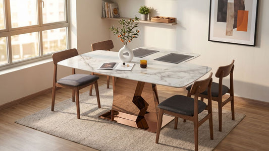 Sintered stone dining table with marble-look top, rose-gold pedestal base, and wooden dining chairs in a warm Singapore dining room