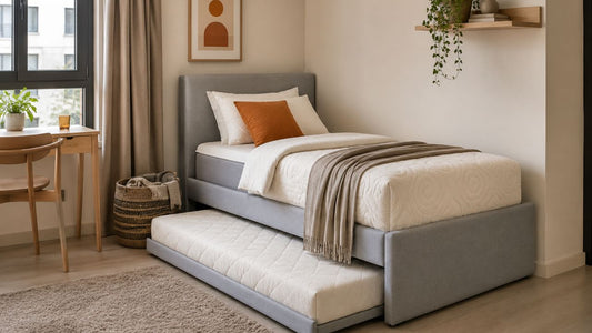 Grey upholstered sofa bed with pull-out mattress in a modern Singapore guest room, showing practical mattress quality and compact home styling