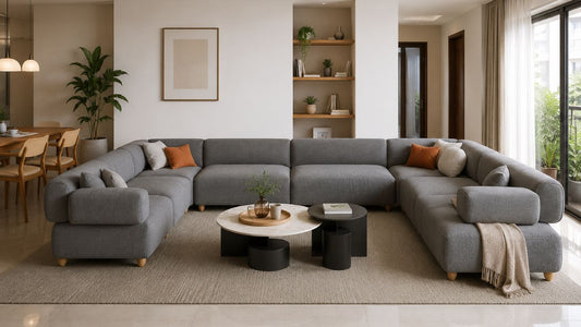 Grey modular sofa set in a warm modern Singapore living room showing a spacious coordinated layout with coffee table and natural daylight