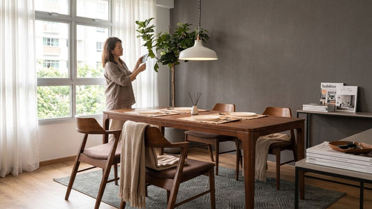 Modern solid walnut wood dining table set in a bright Singapore HDB dining room with Scandinavian style chairs and neutral interior decor