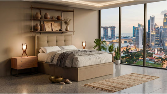Statement upholstered bed in a spacious Singapore condo bedroom with Marina Bay view, warm bedside lighting, and neutral styling
