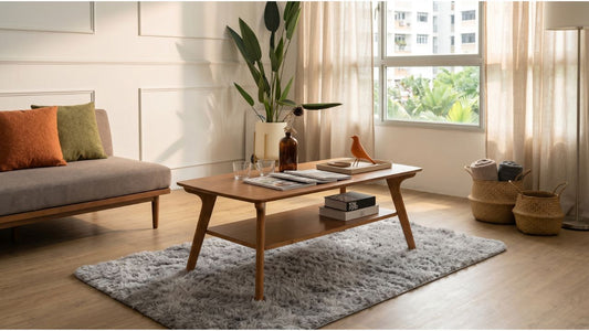 Walnut coffee table with grey sofa and cushions in a bright Singapore HDB living room