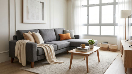 Well-made grey fabric sofa with solid wood base in a bright Singapore living room with coffee table and balcony view