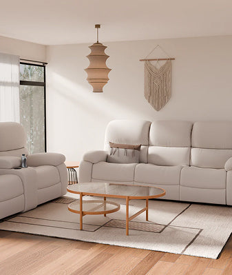Modern living room with couch, table, and lighting.