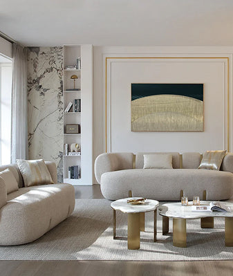 Modern living room with couch, daybed, and natural materials.