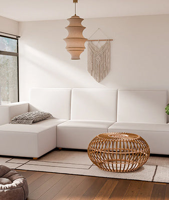 Brown couch and lighting in living room with wood flooring.